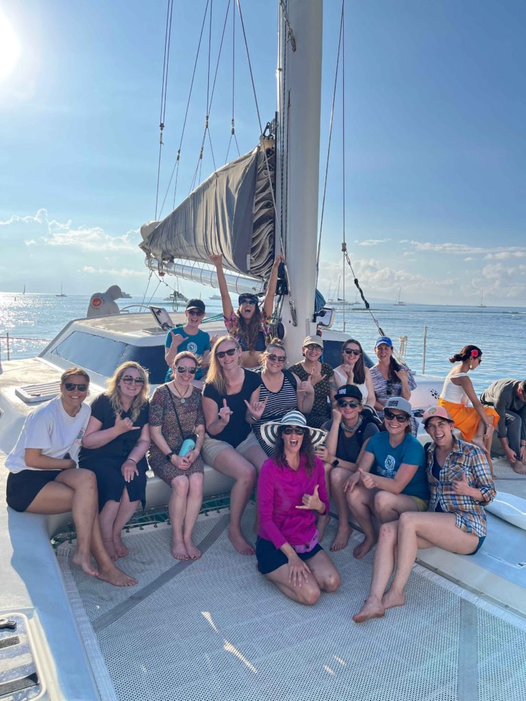 womens surf camp on a sail boat smiling group shot women's surf camp 2026